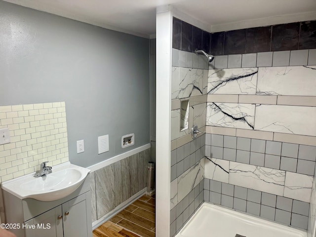 full bathroom featuring vanity, baseboards, wood finished floors, and a shower stall