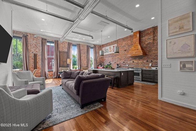 221 Craven St, New Bern, NC 28560 - living area with brick wall, dark wood-style floors, and recessed lighting
