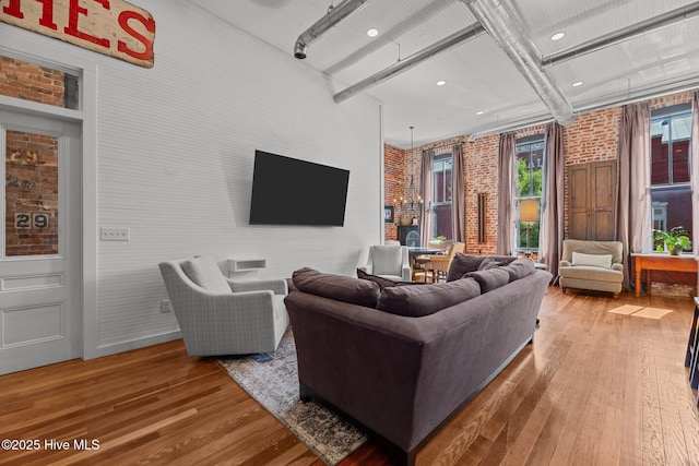 221 Craven St, New Bern, NC 28560 - living area featuring brick wall and hardwood / wood-style flooring