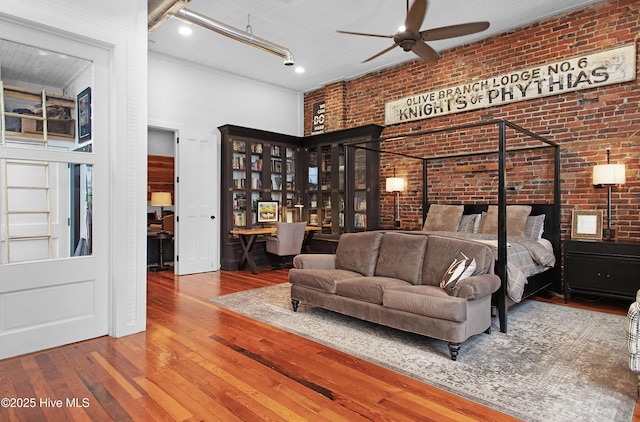 221 Craven St, New Bern, NC 28560 - bedroom with brick wall and wood-type flooring