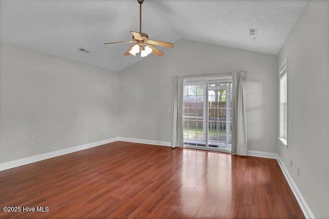 spare room featuring ceiling fan, vaulted ceiling, wood finished floors, and baseboards