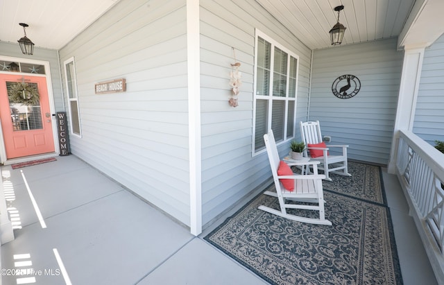 6959 Gracieuse Ln SW, Ocean Isle Beach, NC 28469 - view of exterior entry featuring a porch