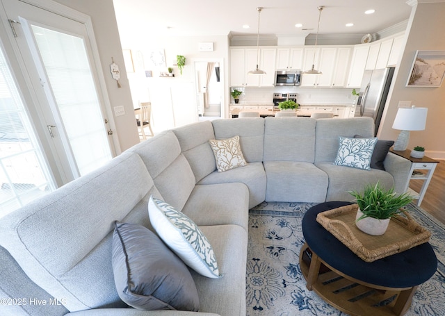 6959 Gracieuse Ln SW, Ocean Isle Beach, NC 28469 - living area with light wood-type flooring, crown molding, recessed lighting, and baseboards