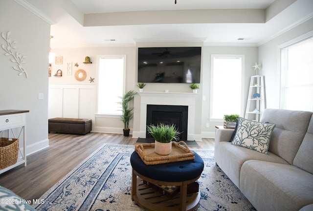 6959 Gracieuse Ln SW, Ocean Isle Beach, NC 28469 - living room with ceiling fan, wood finished floors, healthy amount of natural light, a fireplace with flush hearth, and crown molding