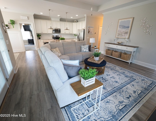 6959 Gracieuse Ln SW, Ocean Isle Beach, NC 28469 - living area featuring dark wood-style flooring, crown molding, baseboards, and recessed lighting