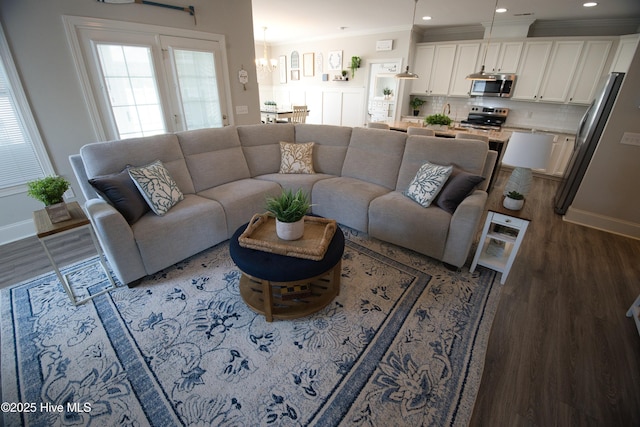 6959 Gracieuse Ln SW, Ocean Isle Beach, NC 28469 - living room featuring wood finished floors, crown molding, a chandelier, baseboards, and recessed lighting