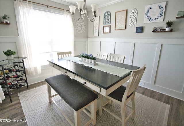 6959 Gracieuse Ln SW, Ocean Isle Beach, NC 28469 - dining space featuring a decorative wall, a chandelier, plenty of natural light, ornamental molding, and dark wood finished floors