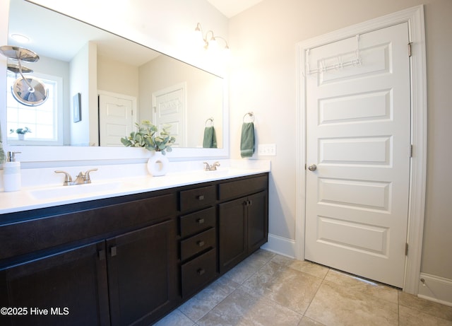 6959 Gracieuse Ln SW, Ocean Isle Beach, NC 28469 - full bath with double vanity, baseboards, and tile patterned floors