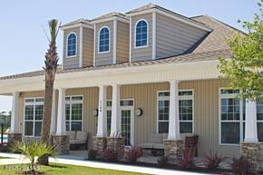 6959 Gracieuse Ln SW, Ocean Isle Beach, NC 28469 - view of front facade featuring covered porch and board and batten siding