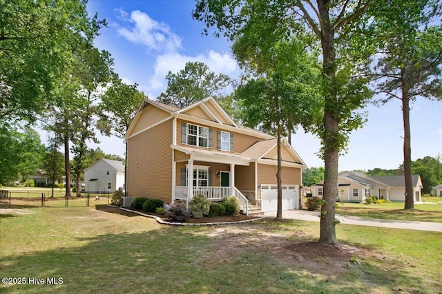 craftsman-style home with covered porch, driveway, an attached garage, and a front yard