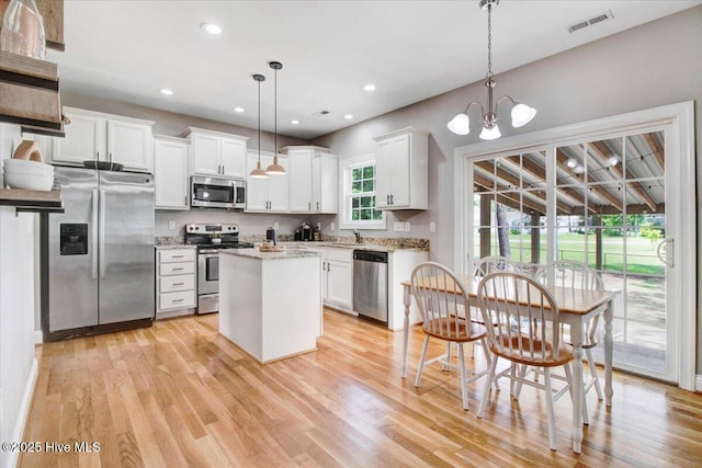 kitchen featuring white cabinets, appliances with stainless steel finishes, and light wood-style flooring