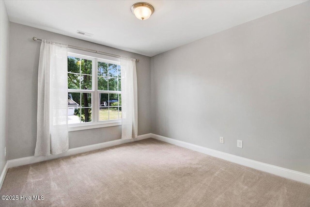 unfurnished room featuring carpet, baseboards, and visible vents