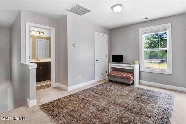 living area with light carpet, baseboards, and visible vents