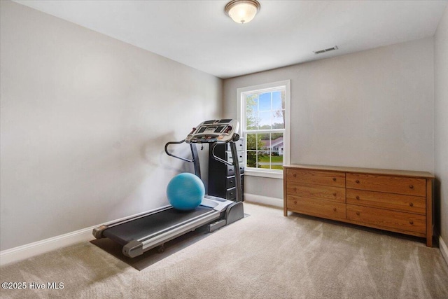 workout area featuring baseboards, visible vents, and carpet floors
