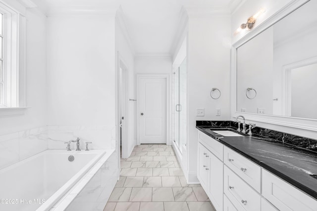 bathroom with marble finish floors, a bath, vanity, crown molding, and a stall shower