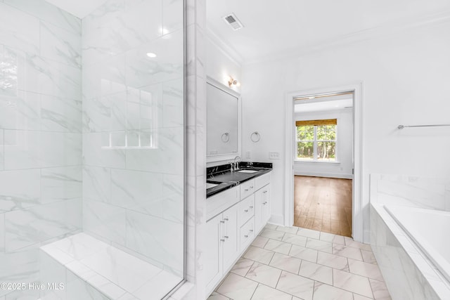bathroom featuring double vanity, ornamental molding, a garden tub, marble look tile flooring, and a shower