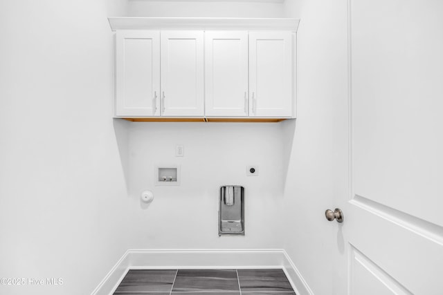 clothes washing area with washer hookup, electric dryer hookup, baseboards, gas dryer hookup, and cabinet space