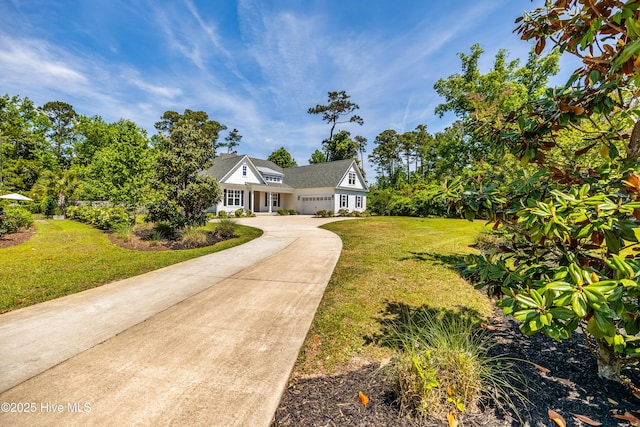 view of front of house with an attached garage, driveway, and a front lawn