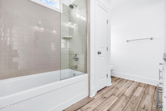 full bath with toilet, shower / bathtub combination, baseboards, and wood finish floors