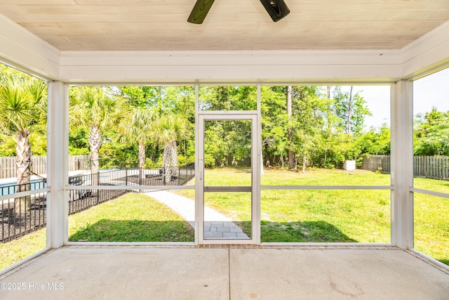 unfurnished sunroom with ceiling fan