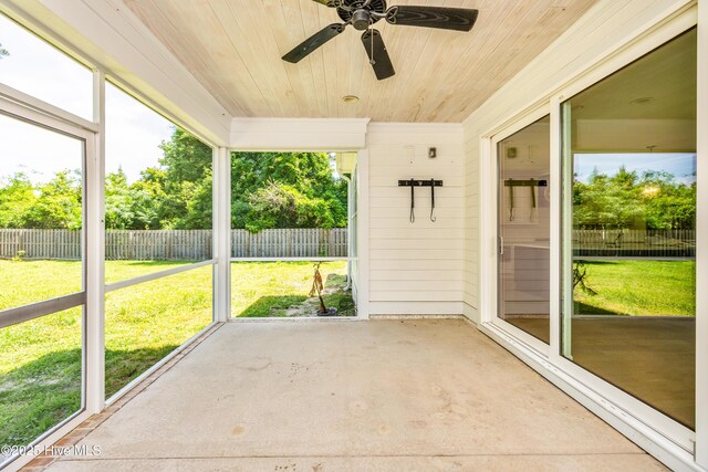 unfurnished sunroom featuring ceiling fan