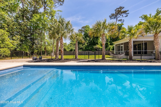 view of pool featuring fence