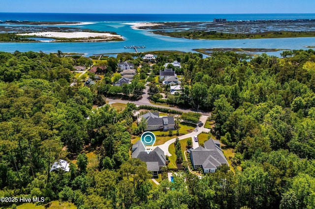 bird's eye view of a nearby body of water and a heavily wooded area