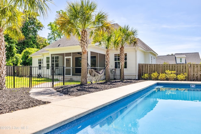 view of pool with a ceiling fan and a gate
