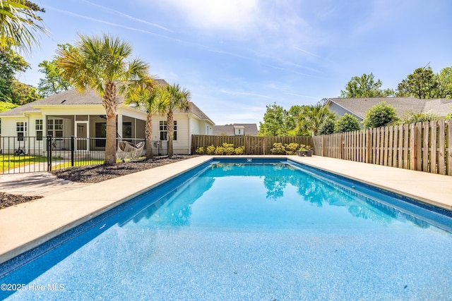 view of swimming pool with a sunroom