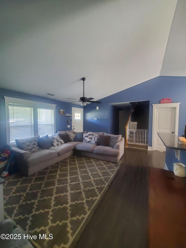 living room featuring dark wood-style flooring, lofted ceiling, and ceiling fan