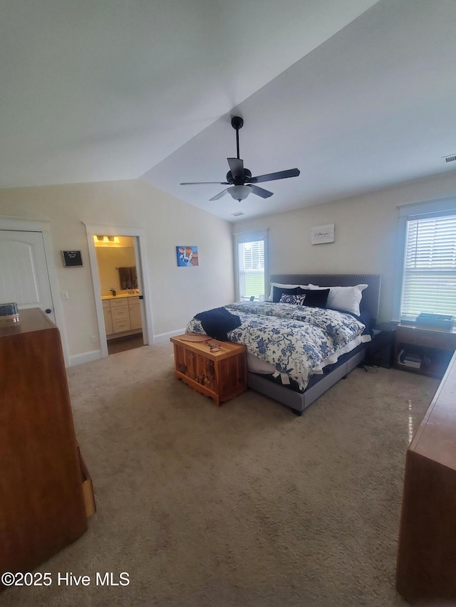 bedroom featuring multiple windows, vaulted ceiling, carpet floors, baseboards, and ceiling fan