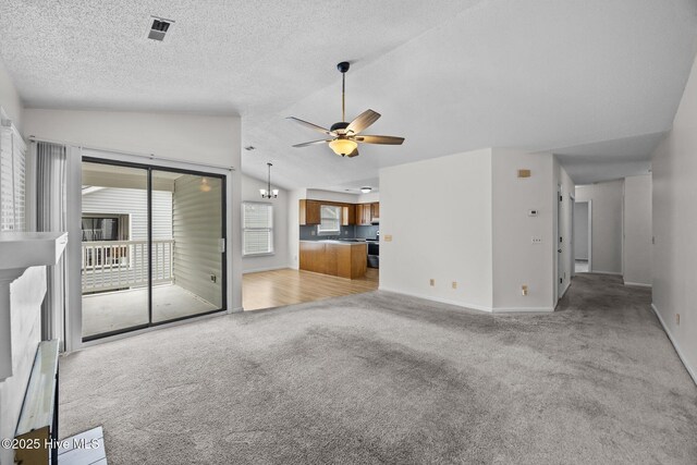 123 W Victoria Ct Unit F, Greenville, NC 27834 - unfurnished living room featuring light colored carpet, ceiling fan, vaulted ceiling, baseboards, and a textured ceiling