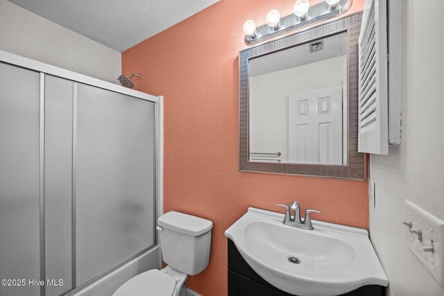123 W Victoria Ct Unit F, Greenville, NC 27834 - bathroom with toilet, vanity, enclosed tub / shower combo, and a textured ceiling
