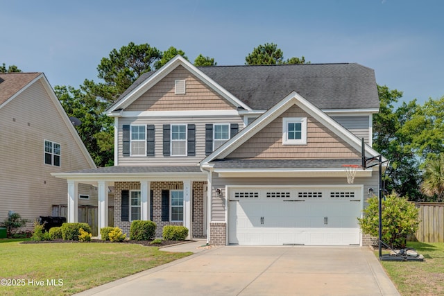 519 W Craftsman Way, Hampstead, NC 28443 - craftsman house featuring driveway, brick siding, a porch, and a shingled roof
