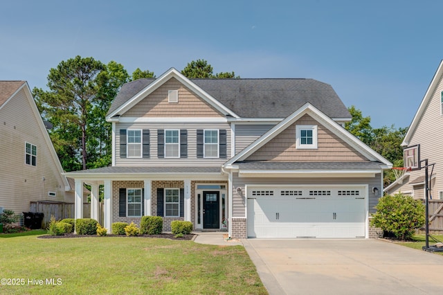 519 W Craftsman Way, Hampstead, NC 28443 - craftsman inspired home with driveway, brick siding, a shingled roof, an attached garage, and a porch