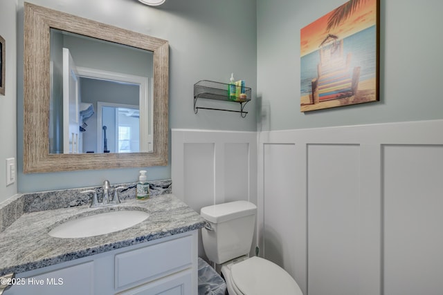 519 W Craftsman Way, Hampstead, NC 28443 - half bathroom featuring vanity, toilet, and wainscoting