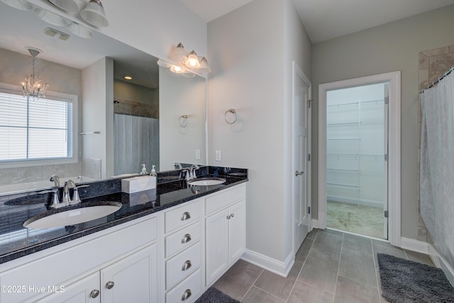 519 W Craftsman Way, Hampstead, NC 28443 - full bath featuring a walk in closet, double vanity, a chandelier, baseboards, and curtained shower