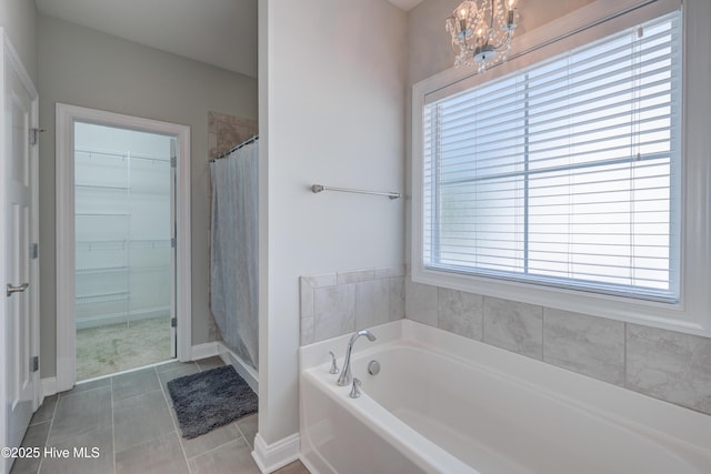 519 W Craftsman Way, Hampstead, NC 28443 - bathroom featuring healthy amount of natural light, a garden tub, a spacious closet, and baseboards