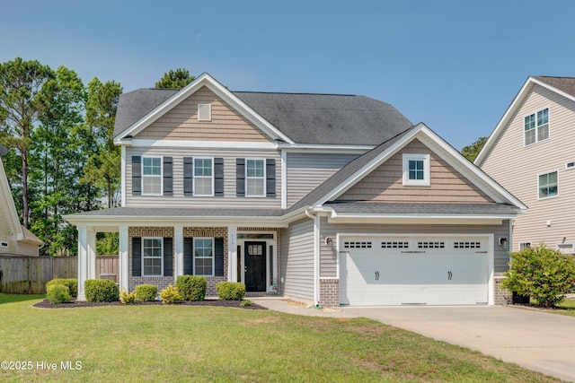 519 W Craftsman Way, Hampstead, NC 28443 - view of front of home featuring concrete driveway, an attached garage, brick siding, and roof with shingles