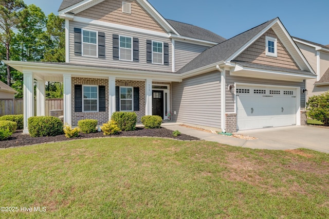 519 W Craftsman Way, Hampstead, NC 28443 - view of front of house with concrete driveway, brick siding, an attached garage, a porch, and a shingled roof