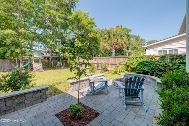 519 W Craftsman Way, Hampstead, NC 28443 - view of patio with a playground and a fire pit