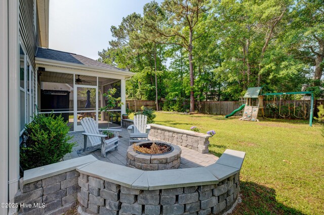 519 W Craftsman Way, Hampstead, NC 28443 - view of patio featuring an outdoor fire pit, a playground, a sunroom, and a ceiling fan