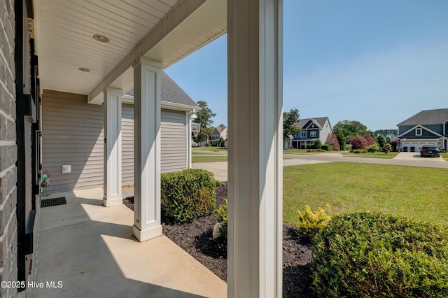 519 W Craftsman Way, Hampstead, NC 28443 - porch featuring a lawn and a residential view