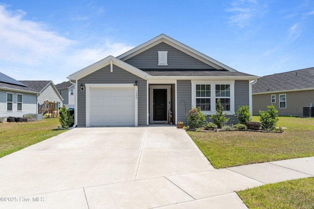 1696 W Coronado Ave SE, Bolivia, NC 28422 - view of front of house featuring an attached garage, concrete driveway, a front lawn, and central AC