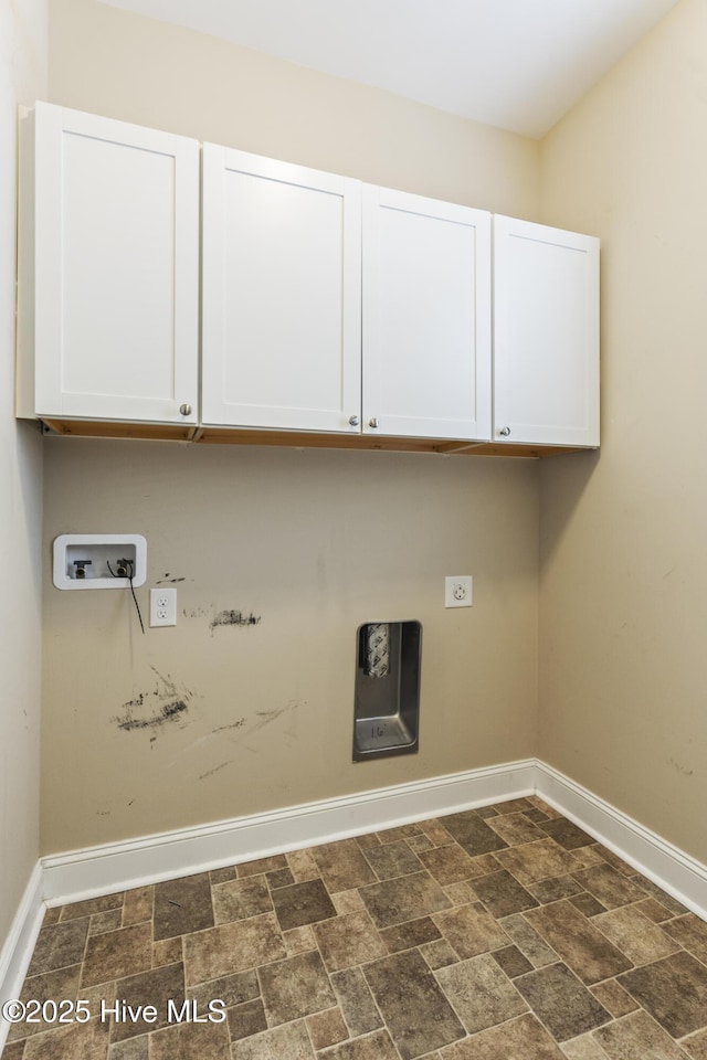 laundry room with cabinet space, baseboards, washer hookup, stone finish flooring, and gas dryer hookup