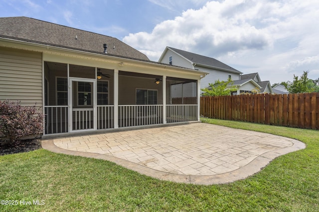 rear view of property featuring ceiling fan, a sunroom, and a patio