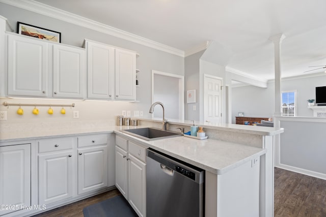 kitchen featuring a peninsula, a sink, white cabinets, stainless steel dishwasher, and ornamental molding