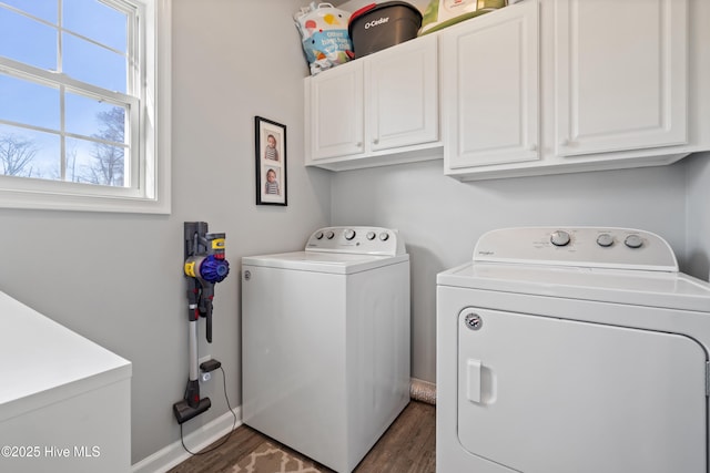 washroom with wood finished floors, cabinet space, baseboards, and washer and dryer