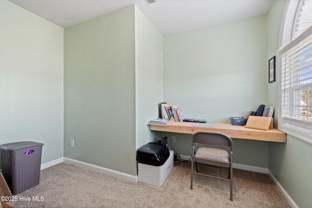 carpeted office featuring baseboards
