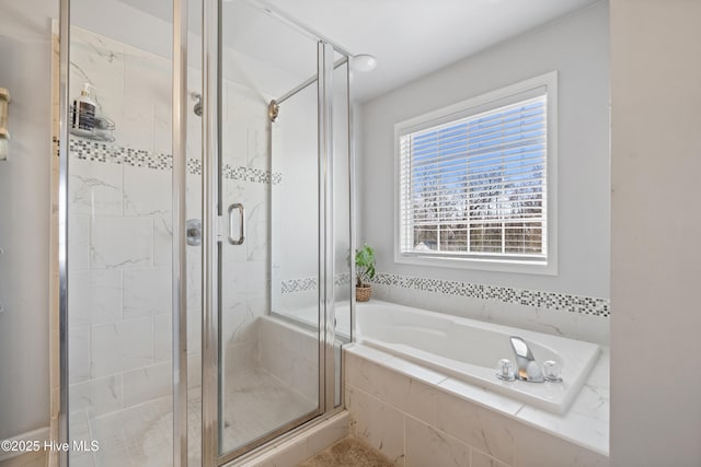 full bath with a bath and a shower stall